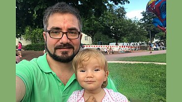 Marc Erni und Tochter. Im Hintergrund ein Park.
